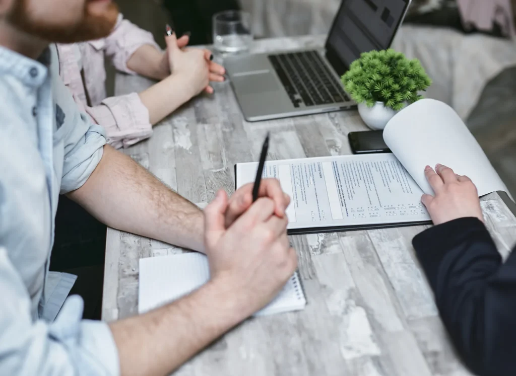 Documents and a laptop arranged for a business discussion
