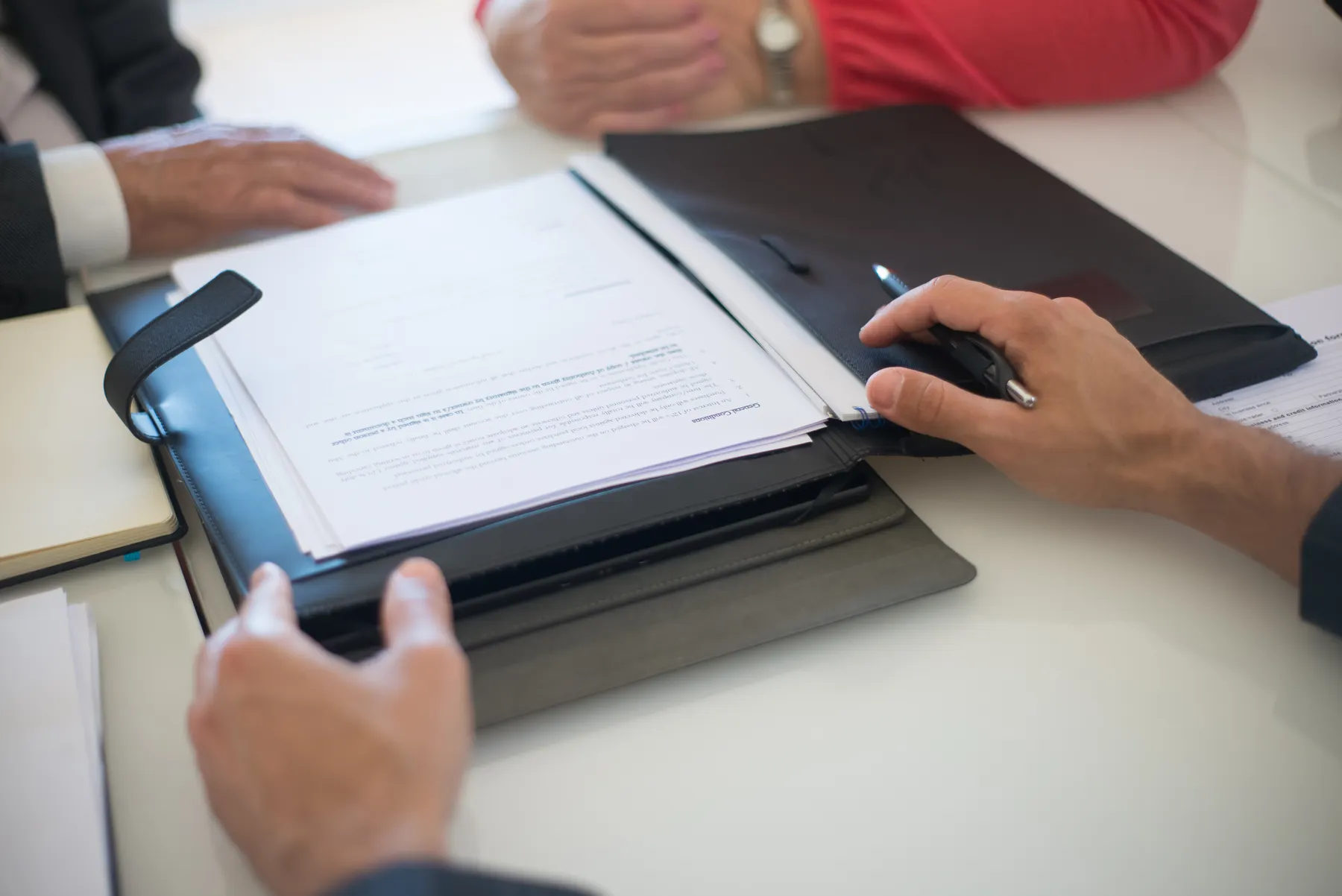 Two people reviewing paperwork together at a table